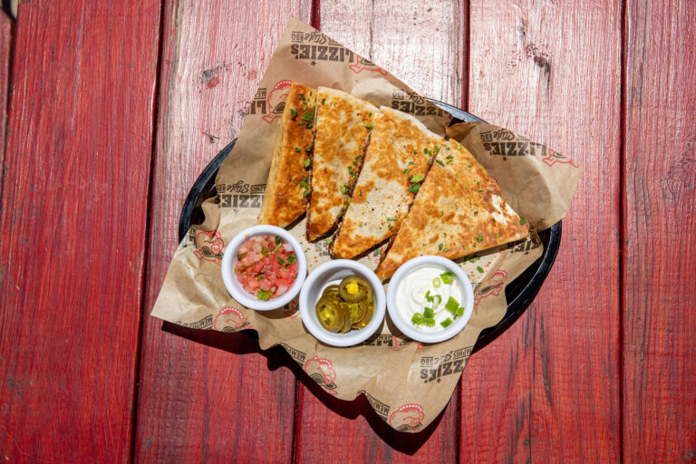 Barbecue quesadillas with sides of pico de gallo, jalapeño, and green onions