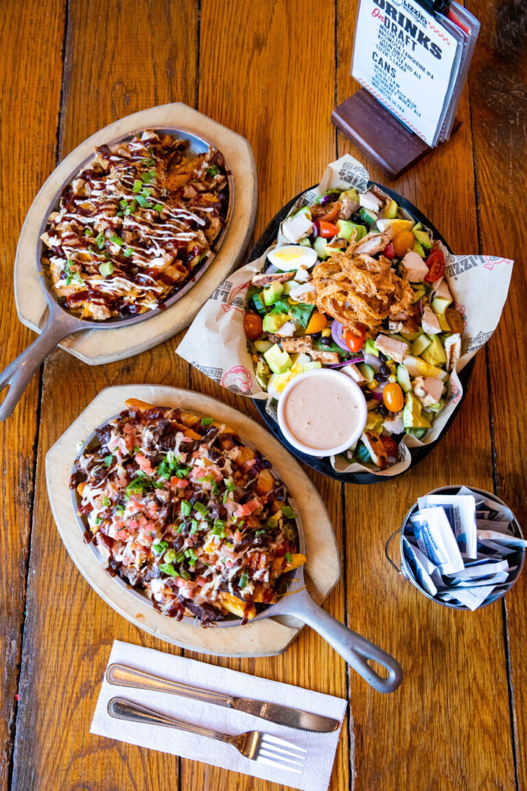Lizzie’s loaded fries on skillets with a side salad